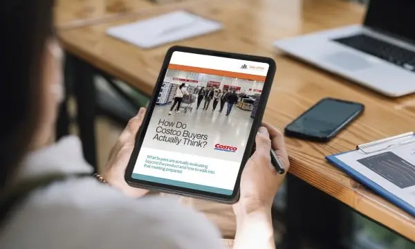 Person looking at one of Bay Cities' Costco Playbooks from its Costco Supplier Hub